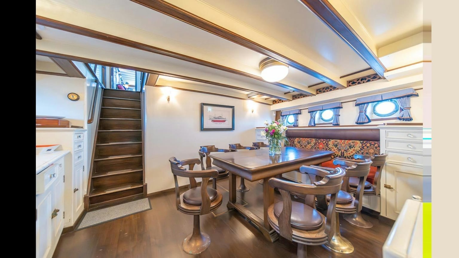 The wood-paneled dining space aboard Blue Peter